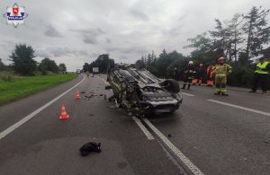 samochód osobowy leżący na jezdni na dachu