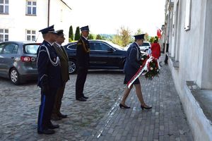 przedstawiciele służb mundurowych składają wiązankę