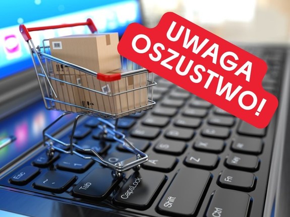 wózek sklepowy na klawiaturze komputera. Wyżej napis "Uwaga oszustwo"