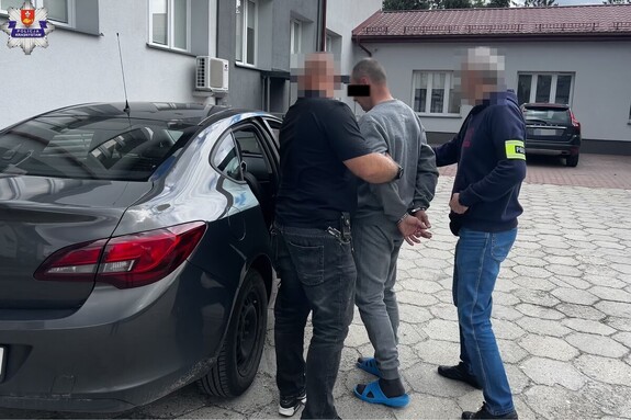 zatrzymany prowadzony przez nieumundurowanych policjantów